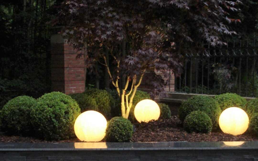 A spherical globe garden light glowing at night